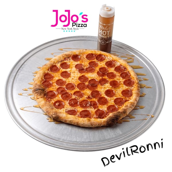 A JoJo's Pizza pepperoni pizza on a metal tray with Mike's Hot Honey drizzled around it.